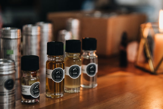 Small bottles with black caps and labels on a wooden surface