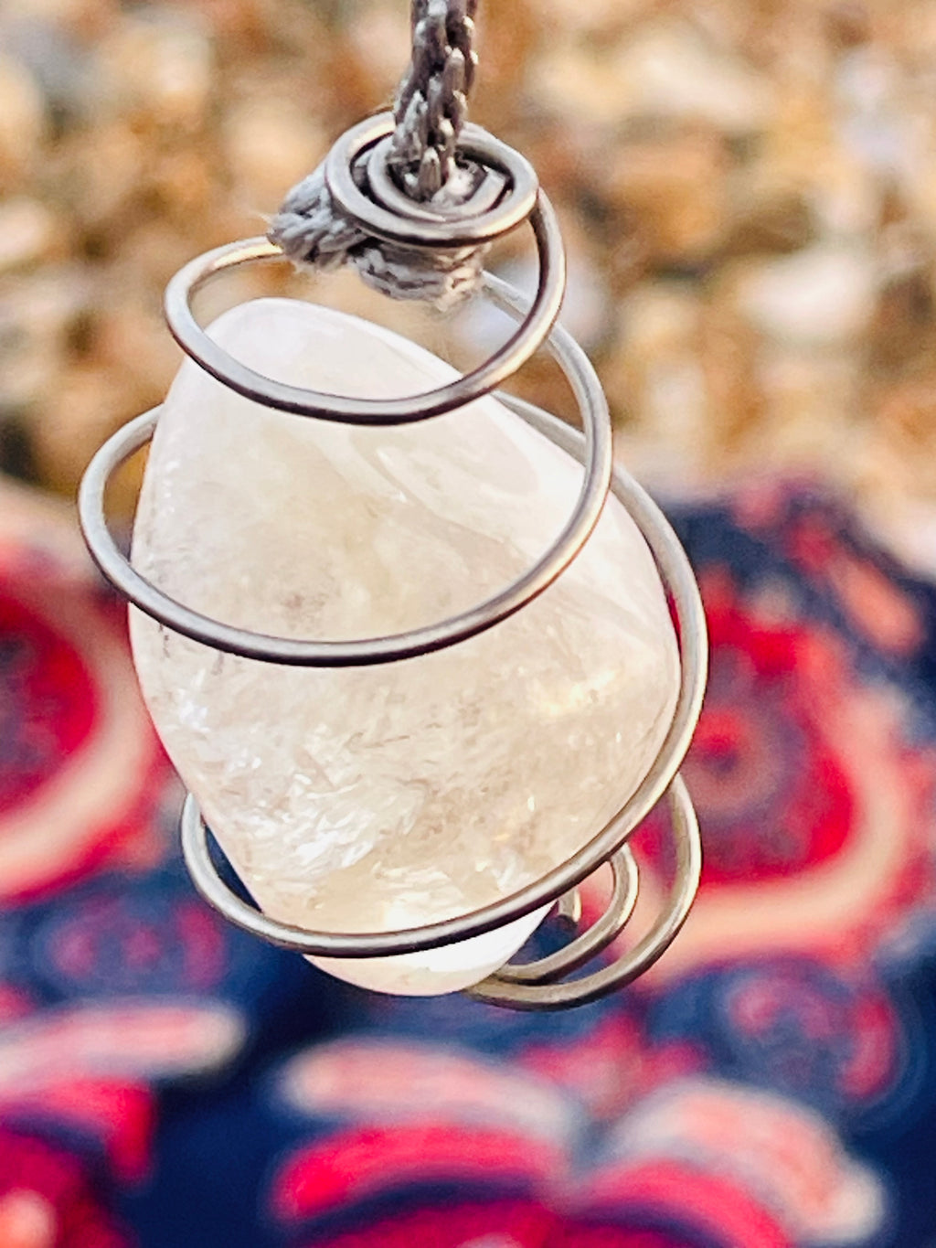 Close-up of a handcrafted natural Citrine crystal pendulum wrapped in Grade 1 titanium wire, highlighting the natural inclusions and polished finish of the stone.