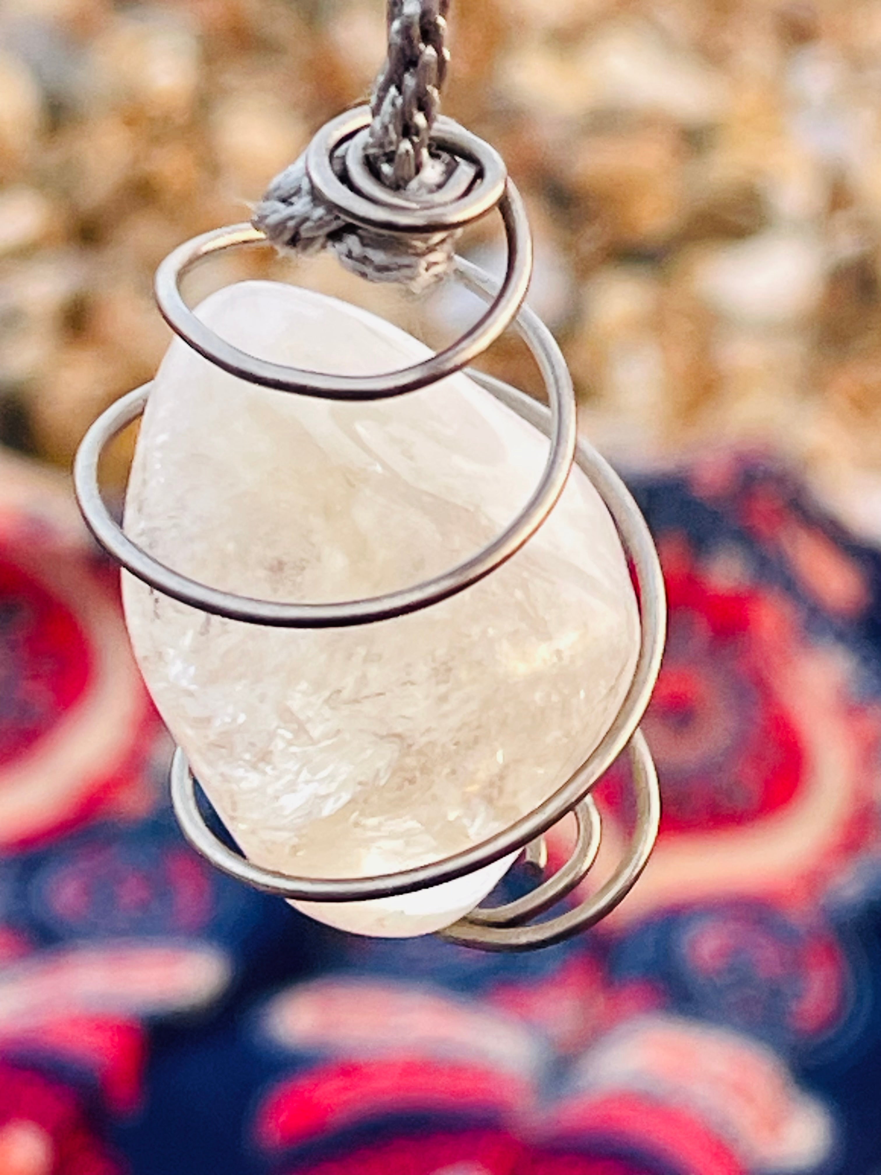 Close-up of a handcrafted natural Citrine crystal pendulum wrapped in Grade 1 titanium wire, highlighting the natural inclusions and polished finish of the stone.