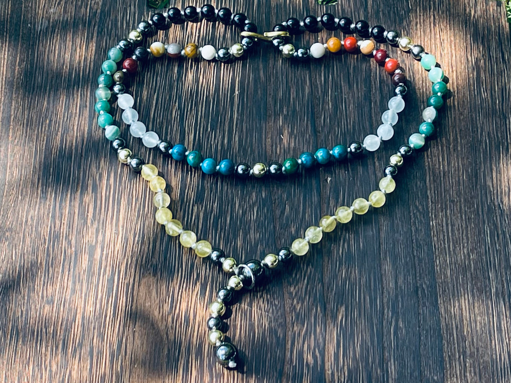 Handcrafted bespoke crystal mala by Starlight Rituals arranged in a heart shape, showcasing the natural gemstone design and individually hand-knotted craftsmanship.