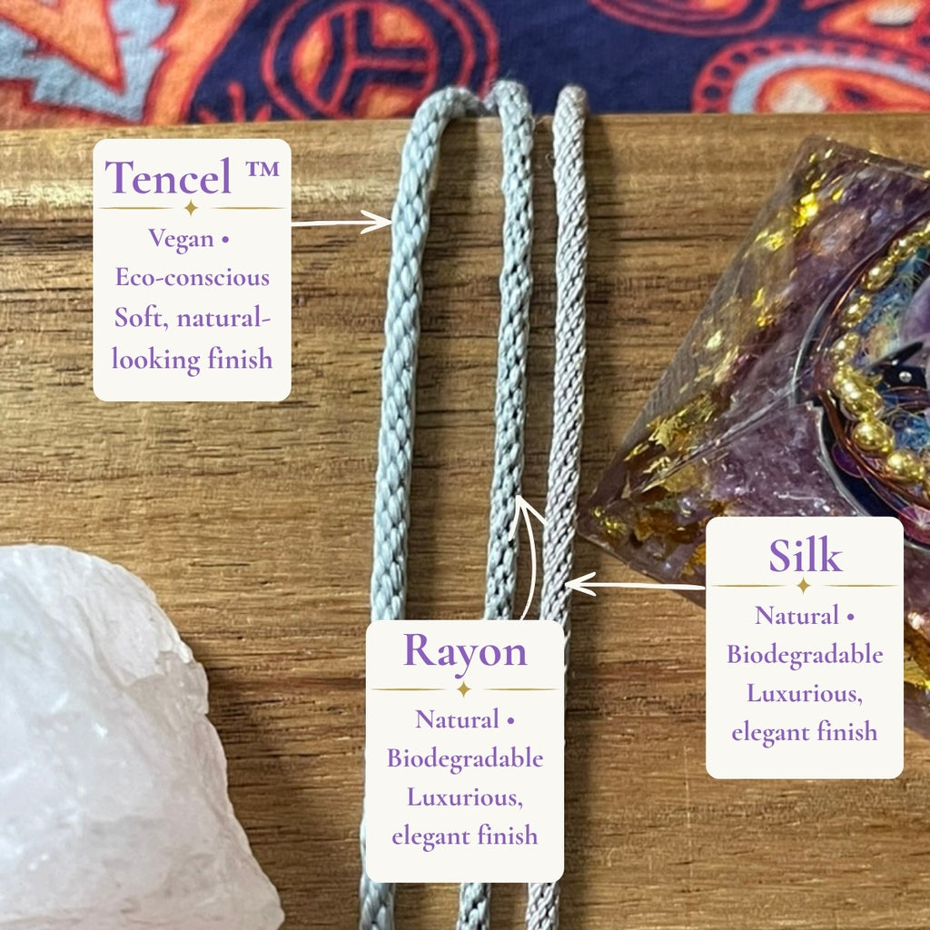 Three silver hand-braided necklace cord options from Starlight Rituals: eco-conscious vegan Tencel, smooth and silky vegan Rayon, and luxurious natural Silk, displayed on a wooden background with crystals.